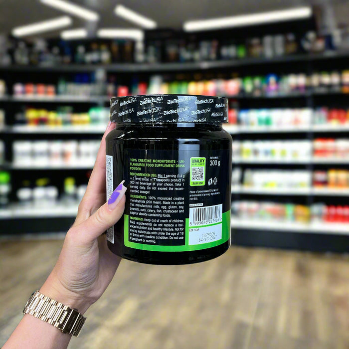 Close-up of (BioTechUSA 100% Creatine Monohydrate, Unflavoured 300g) held up inside My Supplement Shop, clearly showing key ingredients on the packaging in a Sports Nutrition setting.