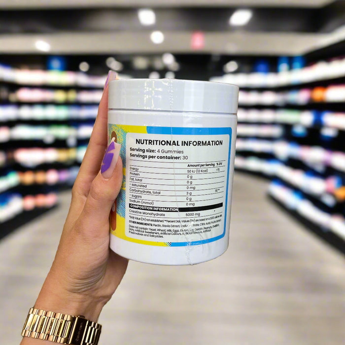 Close-up of (Chaos Crew Creatine Gummies - 120 Gummies) held up inside My Supplement Shop, clearly showing Nutritional Values on the packaging in a Sports Nutrition setting.