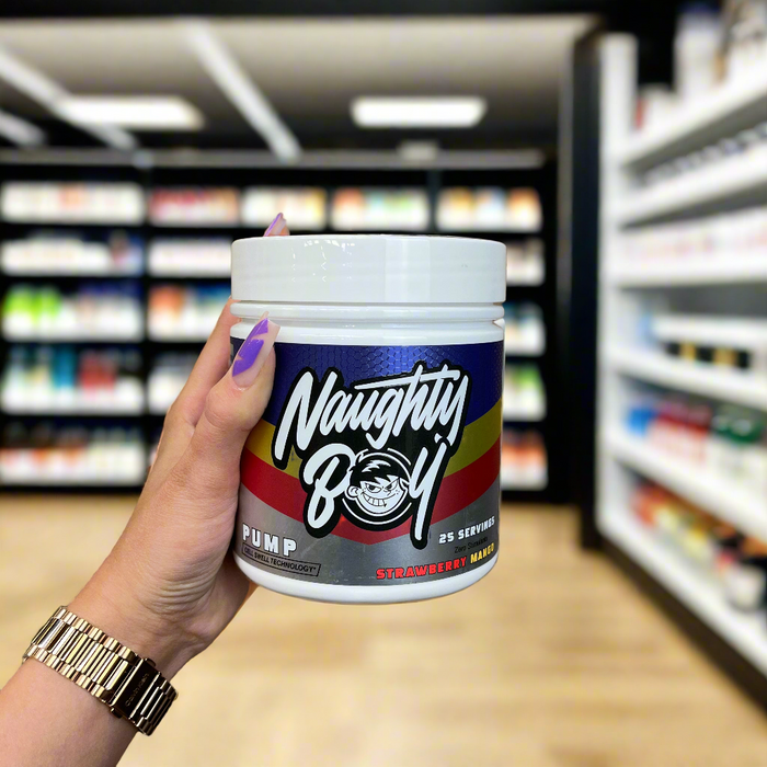 Close-up of (NaughtyBoy® PUMP Stim Free Pre Workout - 25 Servings) held up inside My Supplement Shop, clearly showing the front label in a Sports Nutrition setting.
