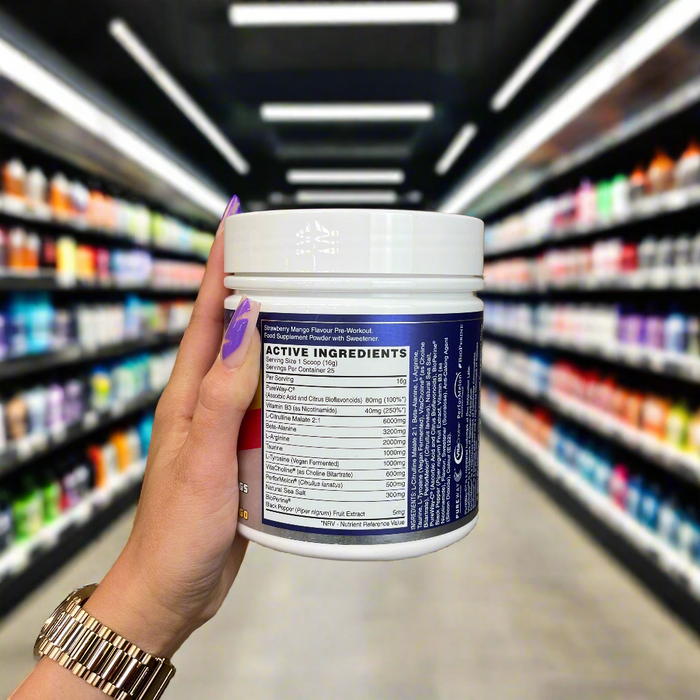 Close-up of (NaughtyBoy® PUMP Stim Free Pre Workout - 25 Servings) held up inside My Supplement Shop, clearly showing key ingredients on the packaging in a Sports Nutrition setting.